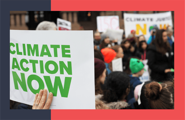 Protestors holding sign that says climate action now.